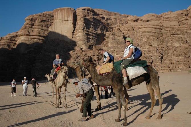 JORDAN Wadi Rum Camel Riding Tourists.jpg